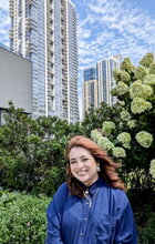 Image of Gabriela G. Corona Valencia standing in front of a skyline 